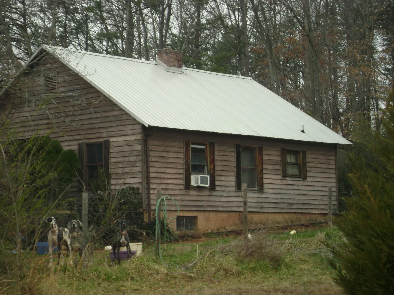 White metal roof on an old wood sided farmhouse, from a Metal Roof Installation job in Aredale
